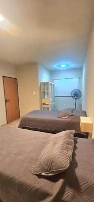 a bedroom with two beds and a room with a closet at Casa Privada Los Cardenales in Nono