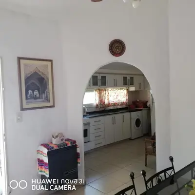 a kitchen with an archway in a house at La Linda in Villa Carlos Paz