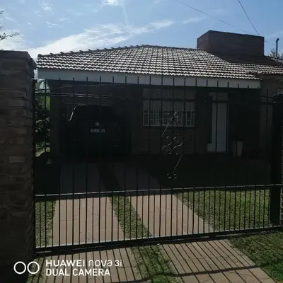 a fence in front of a house at La Linda in Villa Carlos Paz