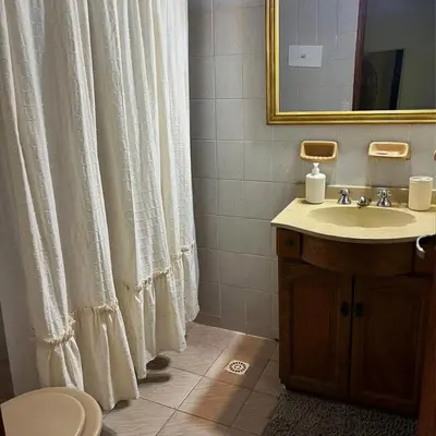 a bathroom with a sink and a shower curtain at Casa Expectacular cerca de la montaña in Villa Carlos Paz