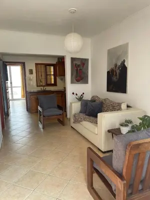 a living room with a couch and a chair at Casa Expectacular cerca de la montaña in Villa Carlos Paz