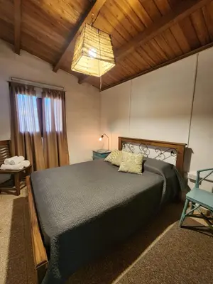 a bedroom with a large bed in a room at Casa del lago los molinos in La Estancia