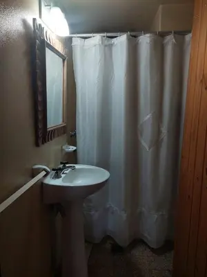 a bathroom with a white shower curtain and a sink at Casa del lago los molinos in La Estancia