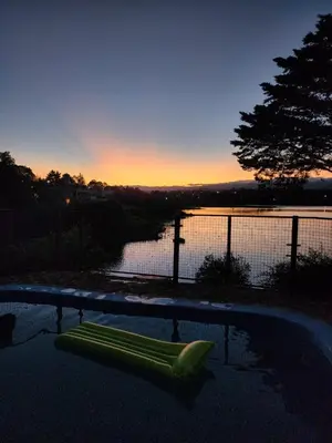 a swimming pool with a green raft in the water at Casa del lago los molinos in La Estancia