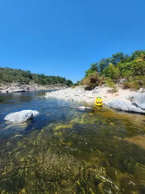 a yellow vehicle in the water on a river at Casa del lago los molinos in La Estancia
