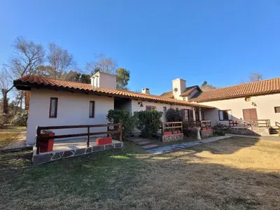 a house with a yard in front of it at Posada Vientos de Belgrano in Villa General Belgrano