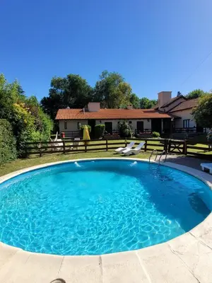 a large pool with blue water in a yard at Posada Vientos de Belgrano in Villa General Belgrano