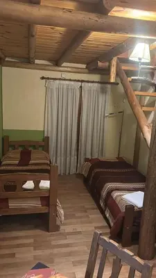 a room with two beds and a window in it at Posada Vientos de Belgrano in Villa General Belgrano