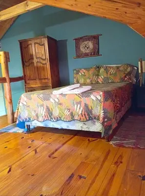 a couch in a living room with a wooden floor at Posada Vientos de Belgrano in Villa General Belgrano