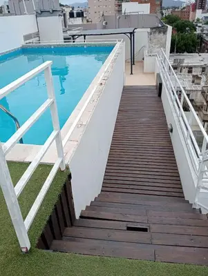 a stairway leading to a swimming pool on top of a building at Nenu Villa Carlos Paz Departamento Céntrico piscina in Villa Carlos Paz