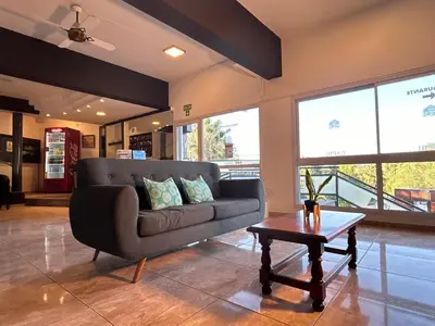 a living room with a couch and a coffee table at Hotel y Cabañas Capri in Villa Carlos Paz