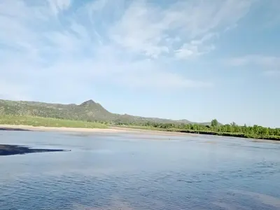 a body of water with mountains in the background at El Descanso in Nono