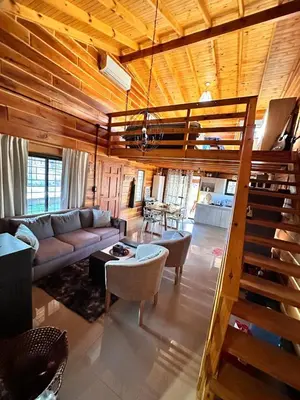 a living room with a couch and a loft at Cabaña para 6 personas en Calamuchita - Córdoba - 