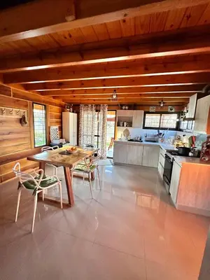 a kitchen with a table and chairs in a room at Cabaña para 6 personas en Calamuchita - Córdoba - 