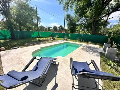 a pair of chairs and a swimming pool at Cabaña para 6 personas en Calamuchita - Córdoba - 