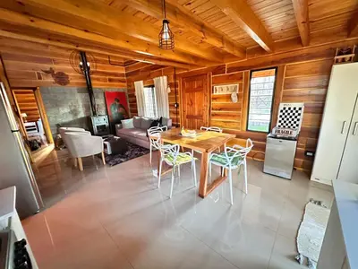 a kitchen and living room with a table and chairs at Cabaña para 6 personas en Calamuchita - Córdoba - 