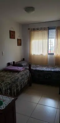 a room with two beds and a window at Samay in Villa Carlos Paz