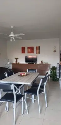 a dining room table with chairs and a ceiling fan at Samay in Villa Carlos Paz