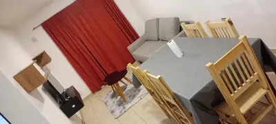 a table and chairs in a room with a red curtain at Depto 1 Dorm Excelente Ubicacion Alta Cordoba Iluminado in Cordoba