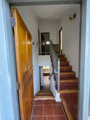 a hallway with stairs with a door and a stair case at Casa de Alvita in Villa Carlos Paz
