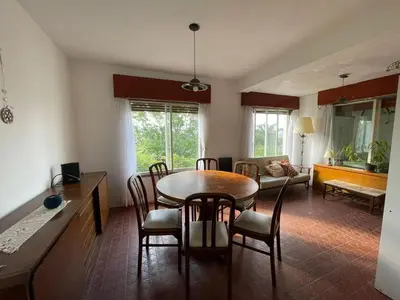 a kitchen and dining room with a table and chairs at Casa de Alvita in Villa Carlos Paz