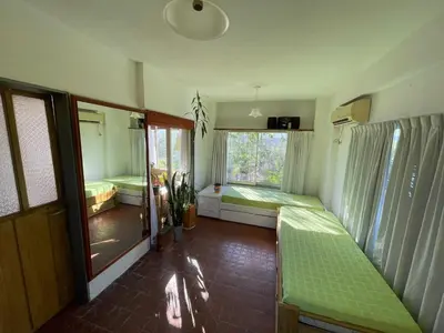 a room with two beds and a window at Casa de Alvita in Villa Carlos Paz