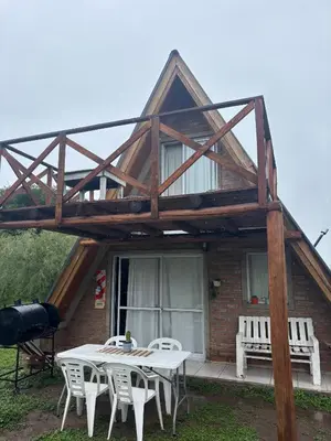 a table and chairs in front of a house at Complejo Ayün in Travesía