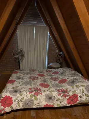 a bedroom with a large bed in a attic at Complejo Ayün in Travesía