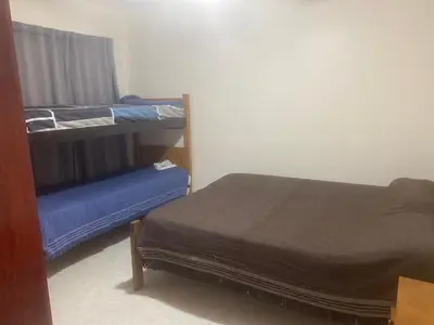 a bedroom with two bunk beds and a blue bed at Depart in Embalse