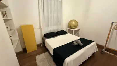 a bedroom with a bed with a stuffed animal on it at Home lab studio in Cordoba