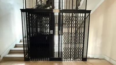 a black gate in a hallway with stairs at Home lab studio in Cordoba