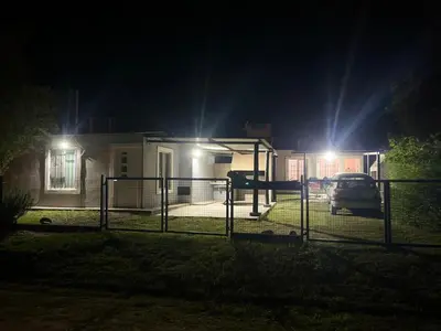 a house with a gate in front of it at night at Timtaya in Barrio Parque El Corcovado