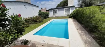 a blue swimming pool in the yard of a house at Timtaya in Barrio Parque El Corcovado