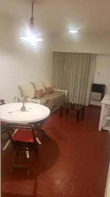 a living room with a table and a couch at Urban 360 in Río Cuarto