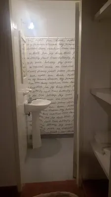 a bathroom with a sink and writing on the wall at Urban 360 in Río Cuarto