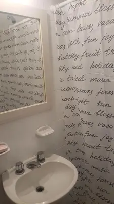 a bathroom with a sink with writing on the wall at Urban 360 in Río Cuarto