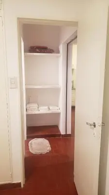 a small room with a white closet with a rug at Urban 360 in Río Cuarto