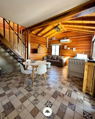a living room with a table and a couch at Terrazas del Algarrobo in Santa Rosa de Calamuchita