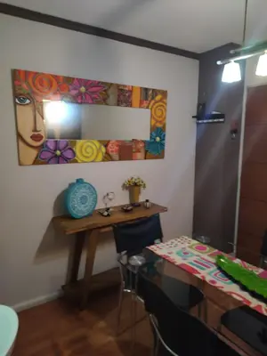 a dining room with a table and a painting on the wall at Apartamento Baykus in Cordoba