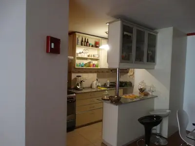 a small kitchen with a white refrigerator and cabinets at Apartamento Baykus in Cordoba