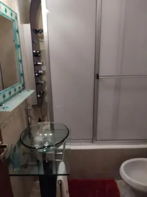 a bathroom with a glass table and a shower at Apartamento Baykus in Cordoba