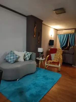 a living room with a couch and a blue rug at Apartamento Baykus in Cordoba