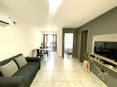 a living room with a couch and a television and a table at Nova Vita in Cordoba
