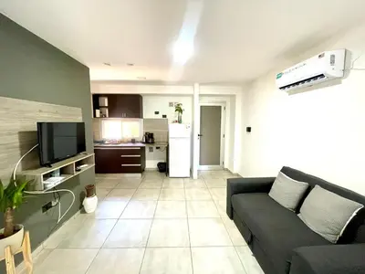 a living room with a couch and a kitchen at Nova Vita in Cordoba