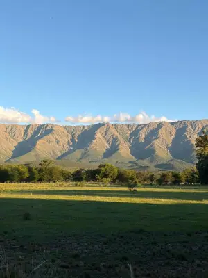 a field with a mountain range in the background at Casita de campo in Las Calles