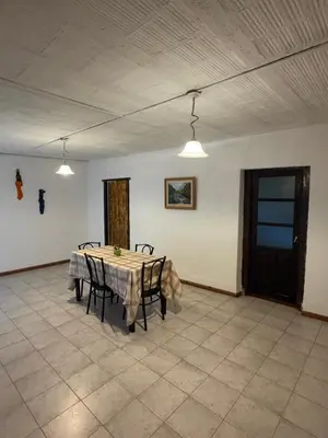 a dining room with a table with chairs and lights at Casita de campo in Las Calles