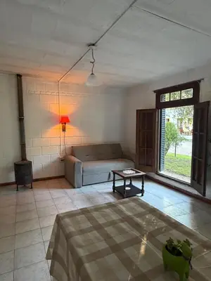 a living room with a couch and a table at Casita de campo in Las Calles