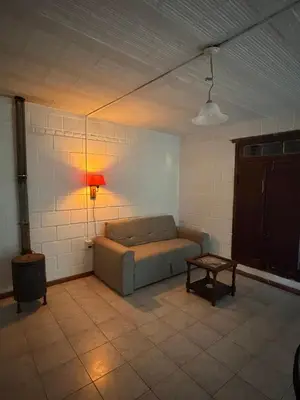 a living room with a couch and a table at Casita de campo in Las Calles