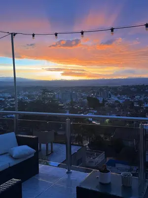 a view of a city at sunset from a balcony at Residencia Premium con Vista Panorámica y Pileta Climatizada in Villa Carlos Paz