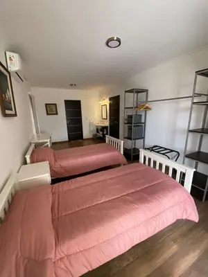 two beds in a room with two beds sidx sidx sidx at Residencia Premium con Vista Panorámica y Pileta Climatizada in Villa Carlos Paz